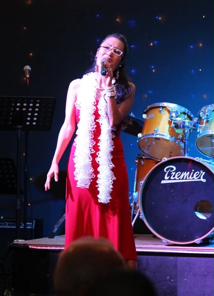 MCyen performing on stage with a full band