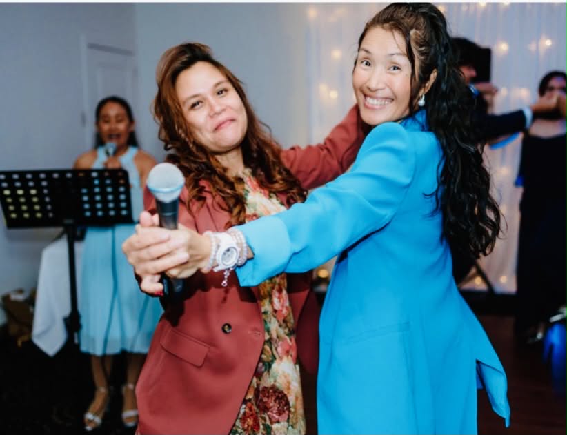 MCyen dancing with a guest at a reception