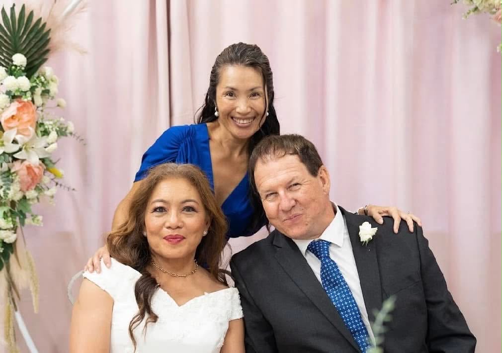 MCyen with a bride and groom at their wedding ceremony